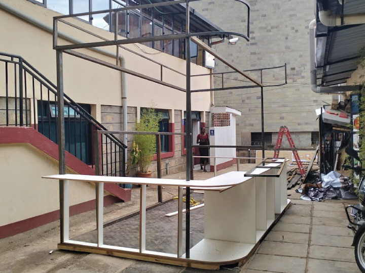 Custom mall kiosk fabrication in Nairobi, Kenya with steel structure and branded panels.