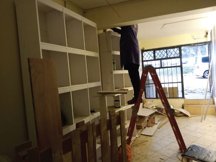 Custom office fabrication in workshop Nairobi Kenya including steel framework, MDF joinery and branded office fittings.