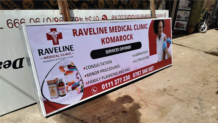 Banner stretching process during framed banner sign fabrication in Nairobi, Kenya.