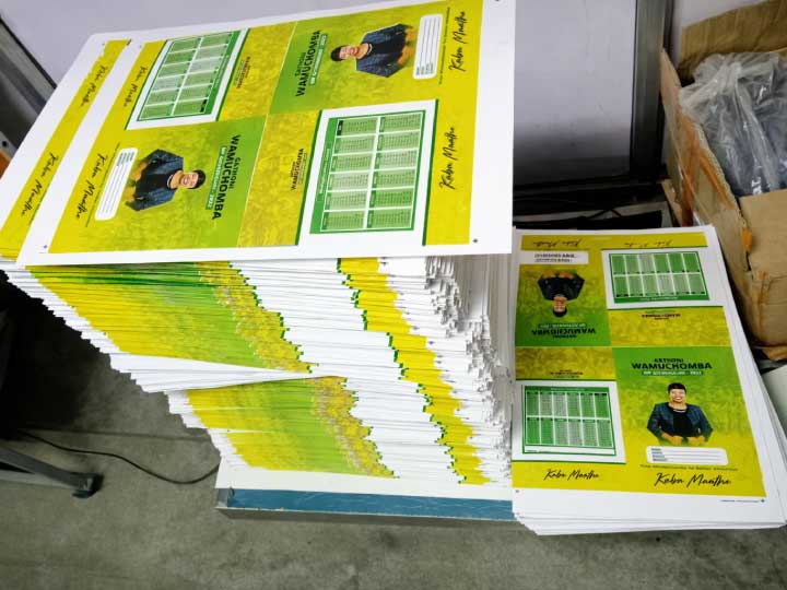 Stack of professionally printed campaign posters in full colour, showcasing large format digital printing services in Nairobi, Kenya.