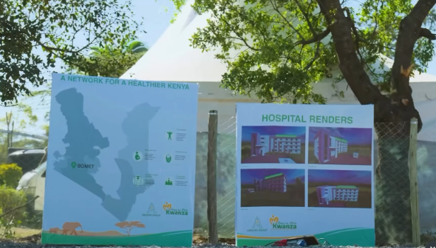 Two outdoor display boards showing a map of Kenya and hospital illustrations.